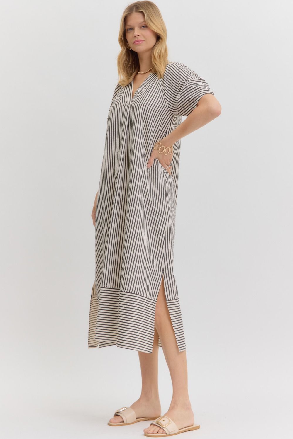 Women's black and white striped fall midi dress, side view