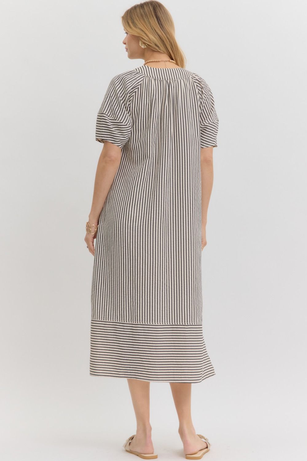 Women's black and white striped fall midi dress, back view