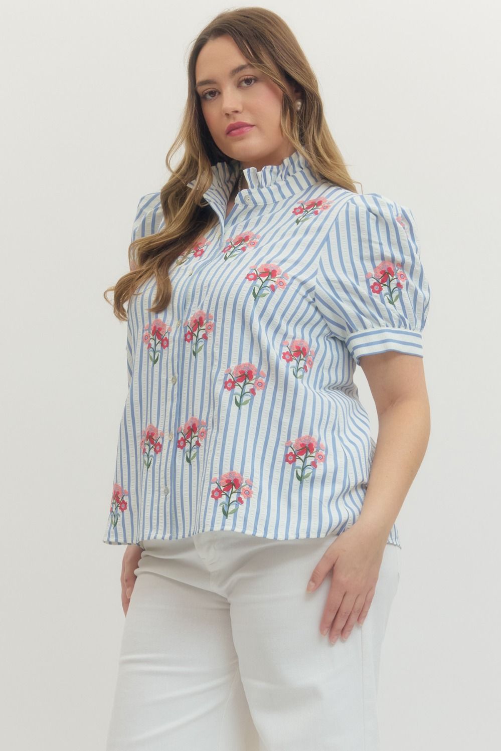 Entro blue and white striped button front top with pink and red embroidered flowers showing side silhouette