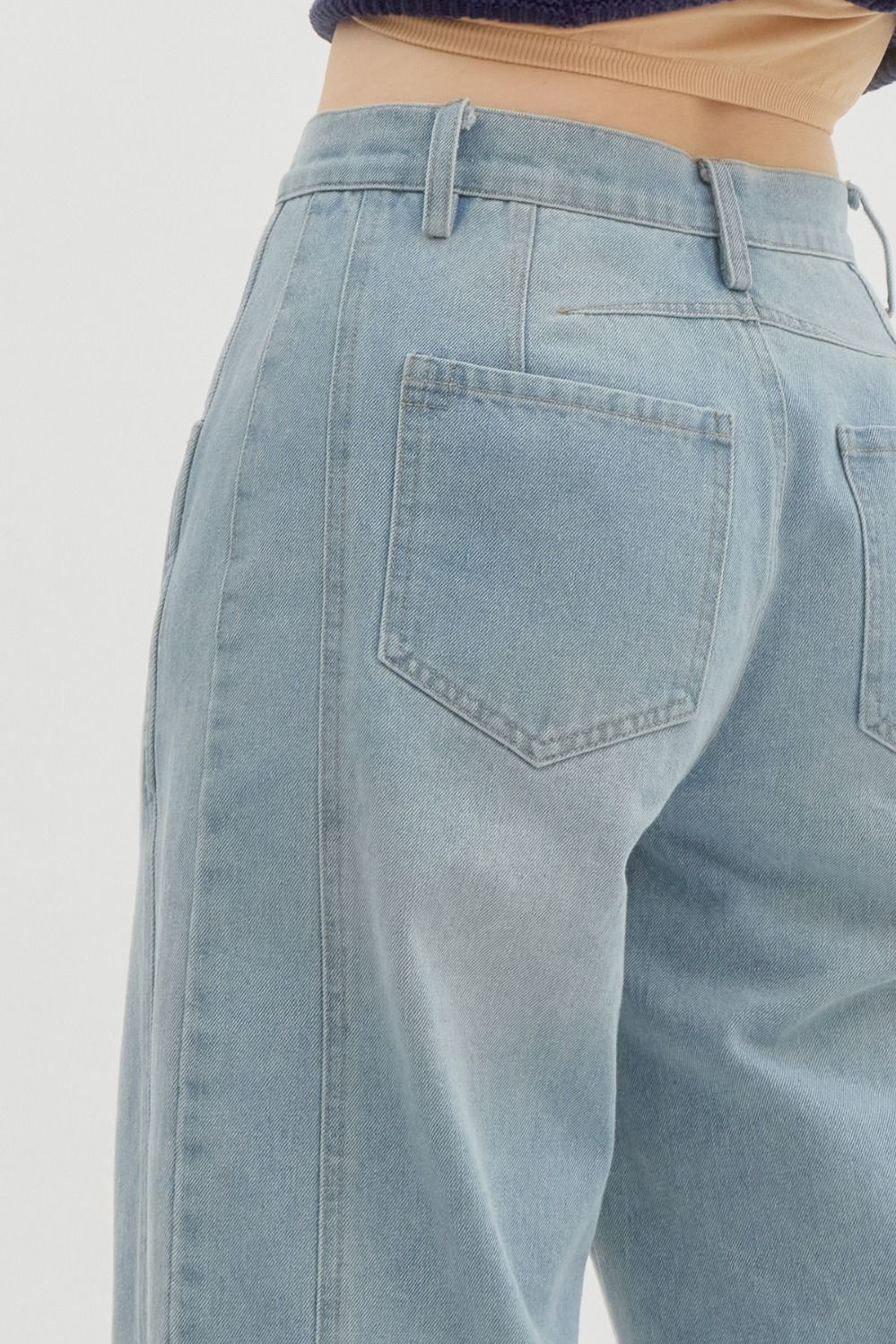 Women's Entro Brand light washed denim barrel jeans showing slight back view