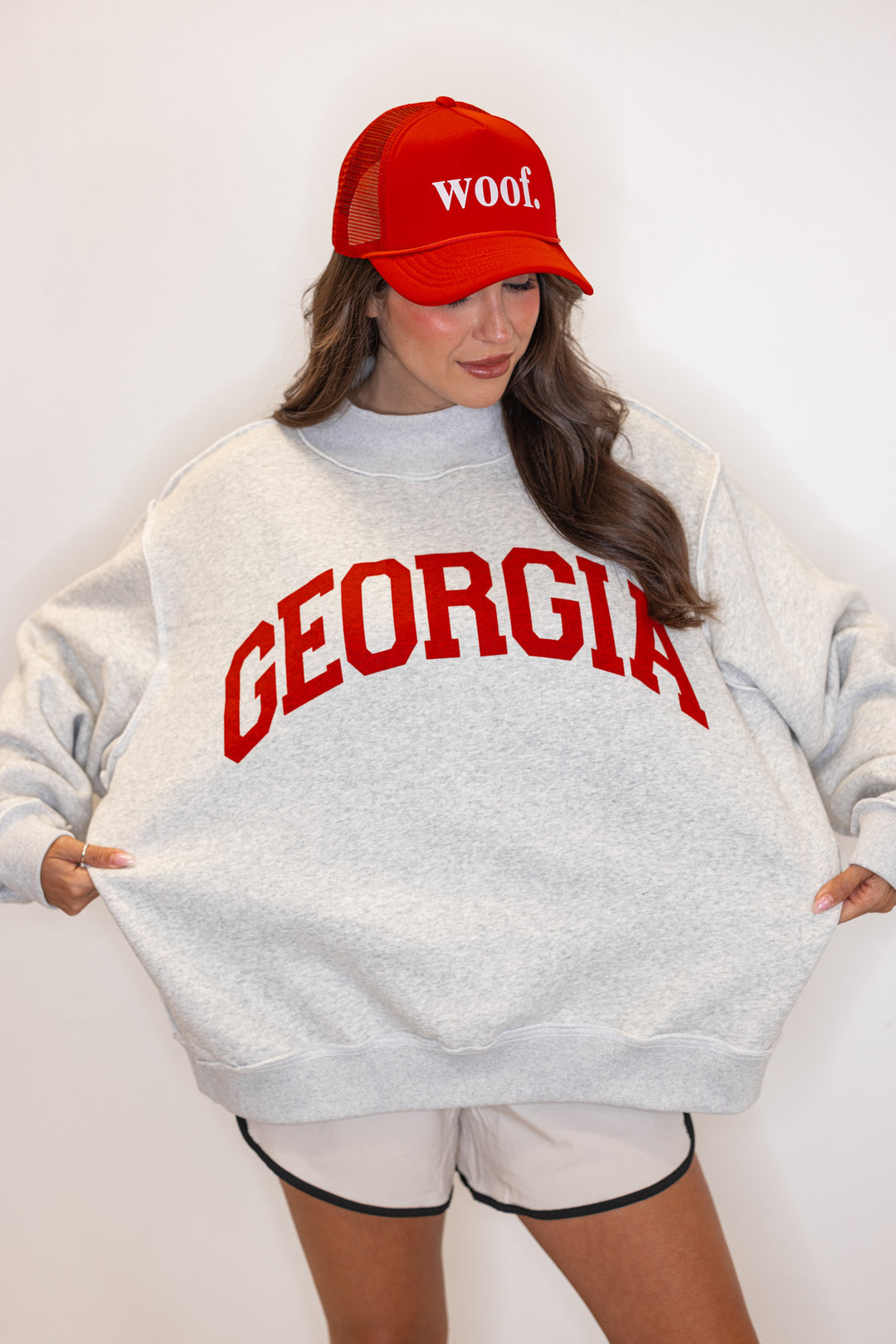 Women's "Georgia/GA" sweatshirt in reversible grey and red or white and red by BucketList showing oversized fit of heather grey side