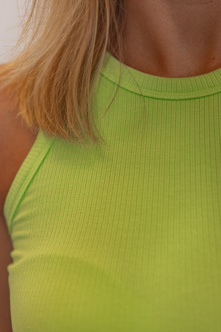 Women's ribbed tank top in lime green by Karlie showing up close ribbed detail