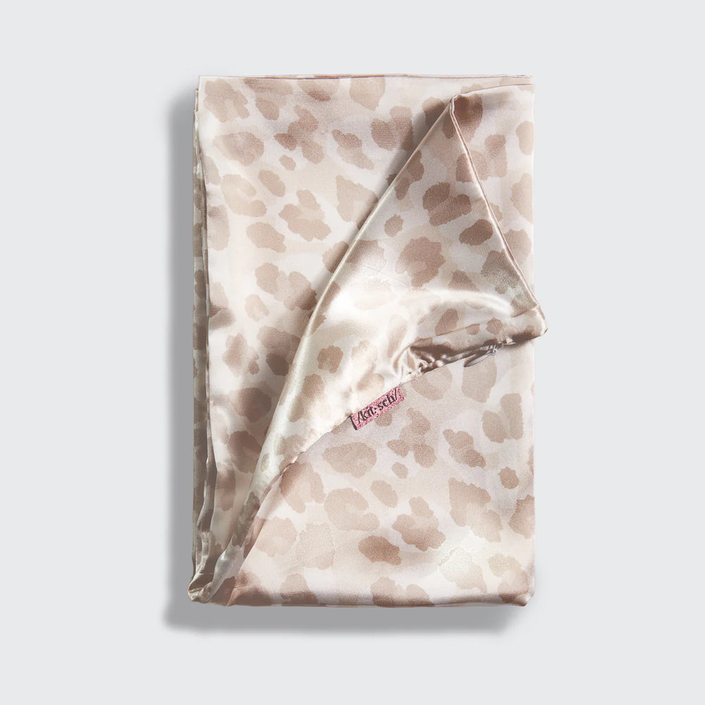 Folded satin pillow case with a subtle leopard pattern