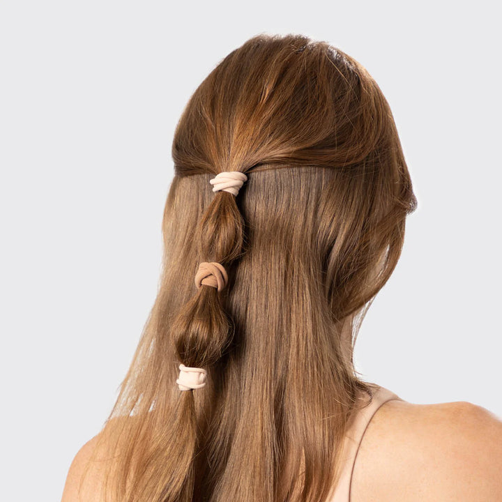 Kitsch seamless nylon hair ties shown on ladies ponytail