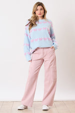 Light blue sweater striped with textured lavender/pink bow ties