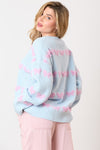 Light blue sweater striped with textured lavender/pink bow ties