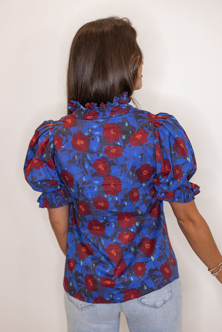 Dark blue puff sleeve top with navy and burgundy floral print by Entro showing up close back view