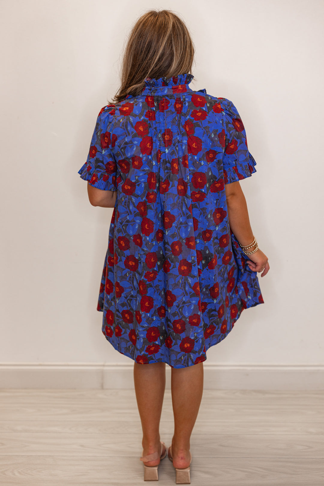 Women's dark blue and burgundy floral dress with pleated bodice and ruffle details by Entro showing full back view
