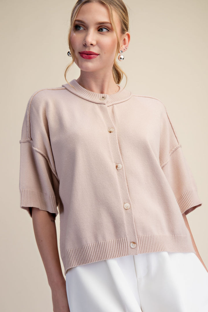 Beige button front knit top with short sleeves and drop shoulder