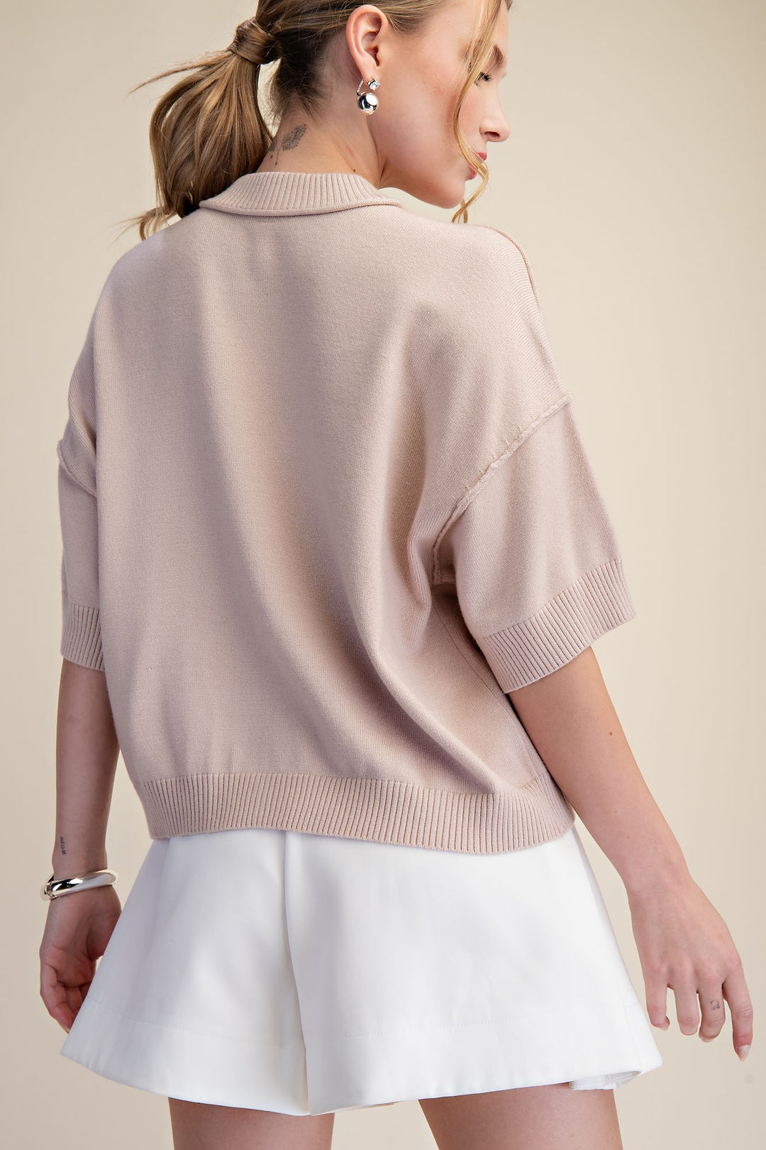 Beige button front knit top with a flattering silhouette