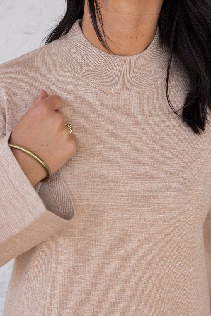 Women's sand beige knit long sleeve midi sweater dress by Entro showing ribbed neckline