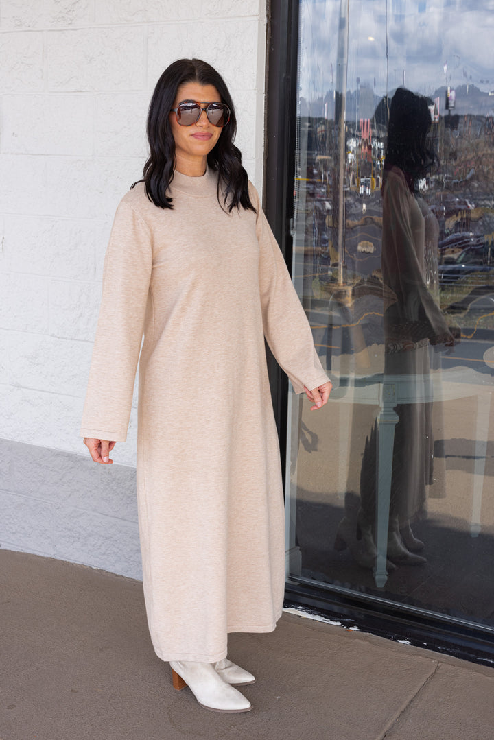Women's sand beige knit long sleeve midi sweater dress by Entro showing slight side view