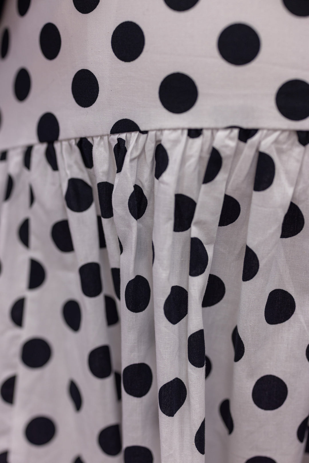 Women's black polka dot maxi skirt by Day + Moon showing polka dot pattern