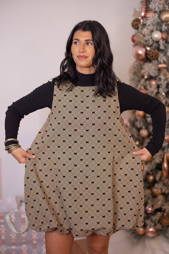 Women's brown, taupe and black gingham bubble hem dress with black bow ties by Glam showing true to size fit