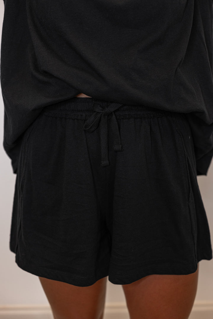 Black cotton slub knit shorts and top set by Rae Mode showing relaxed fit of shorts