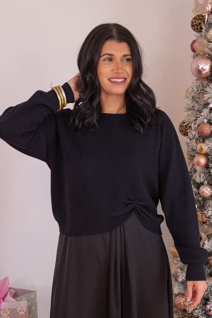 Women's black knit cropped sweater top with knotted detail at the hem by Jodifl showing up close front view