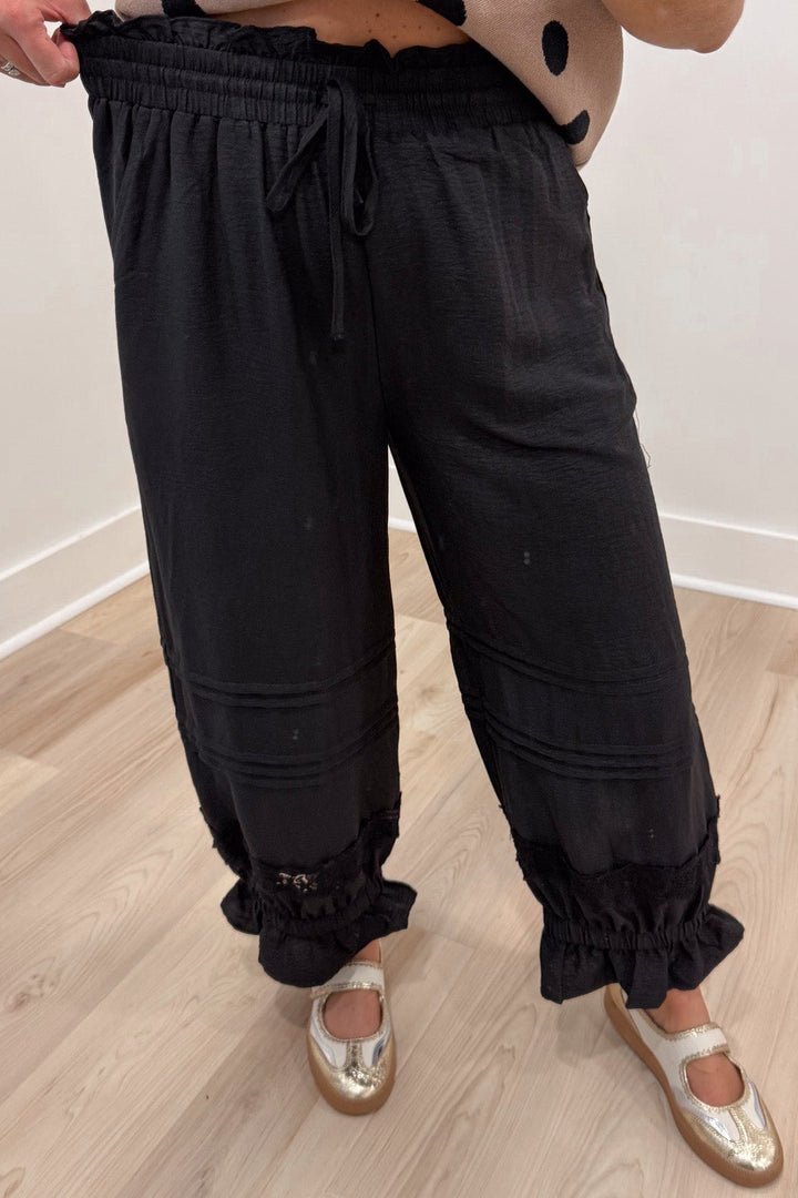 solid black drawstring elastic waist wide leg cropped pants with elastic ruffle cuffed ankles