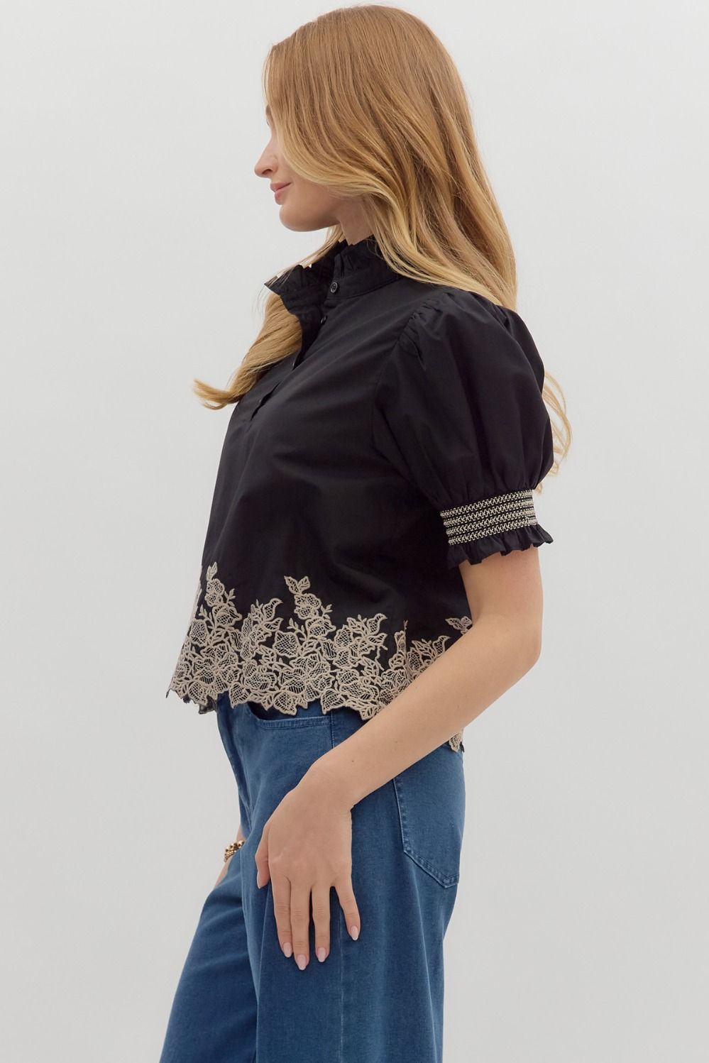 Women's black puff sleeve top with cream embroidered floral details by Entro showing side view