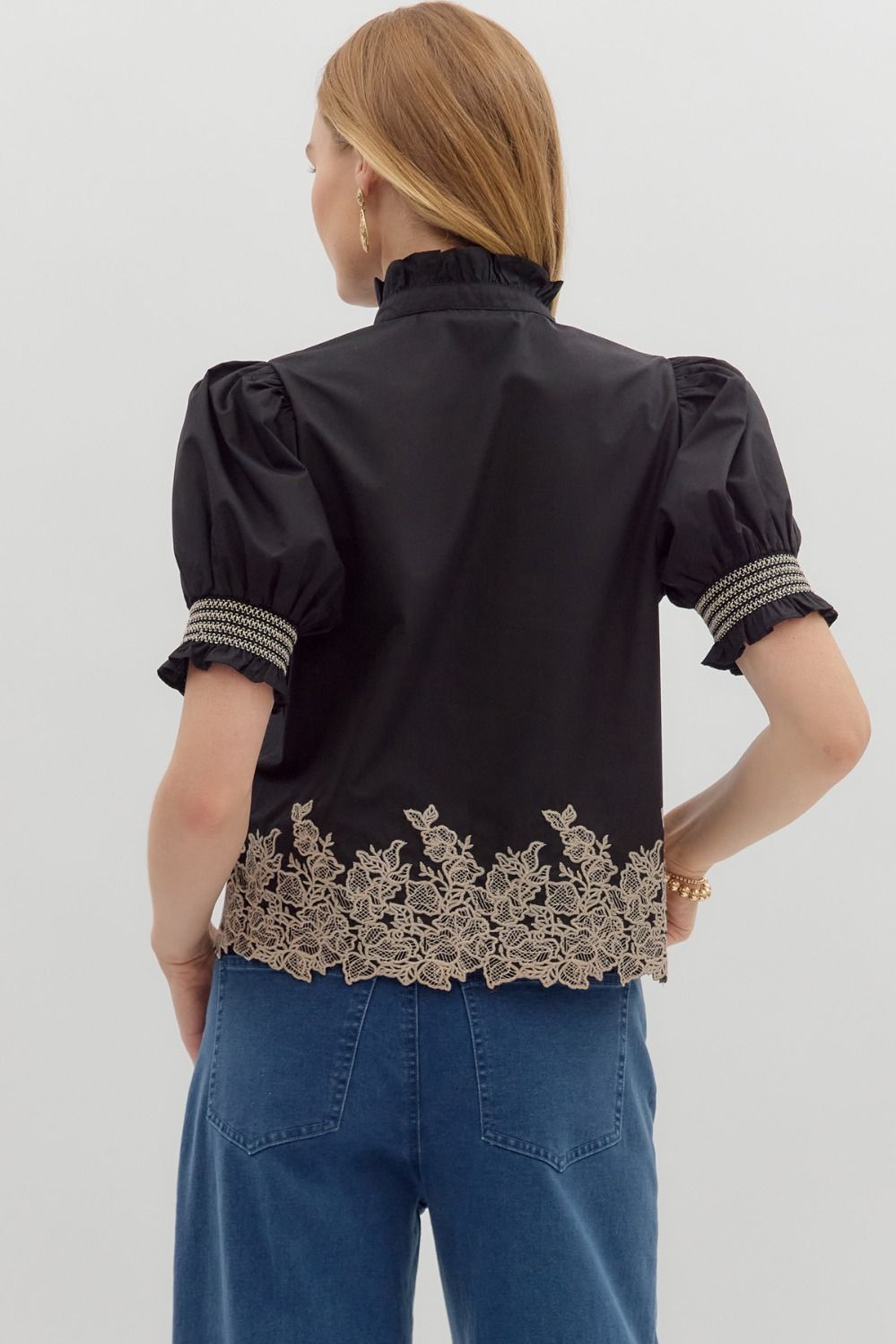 Women's black puff sleeve top with cream embroidered floral details by Entro showing back view