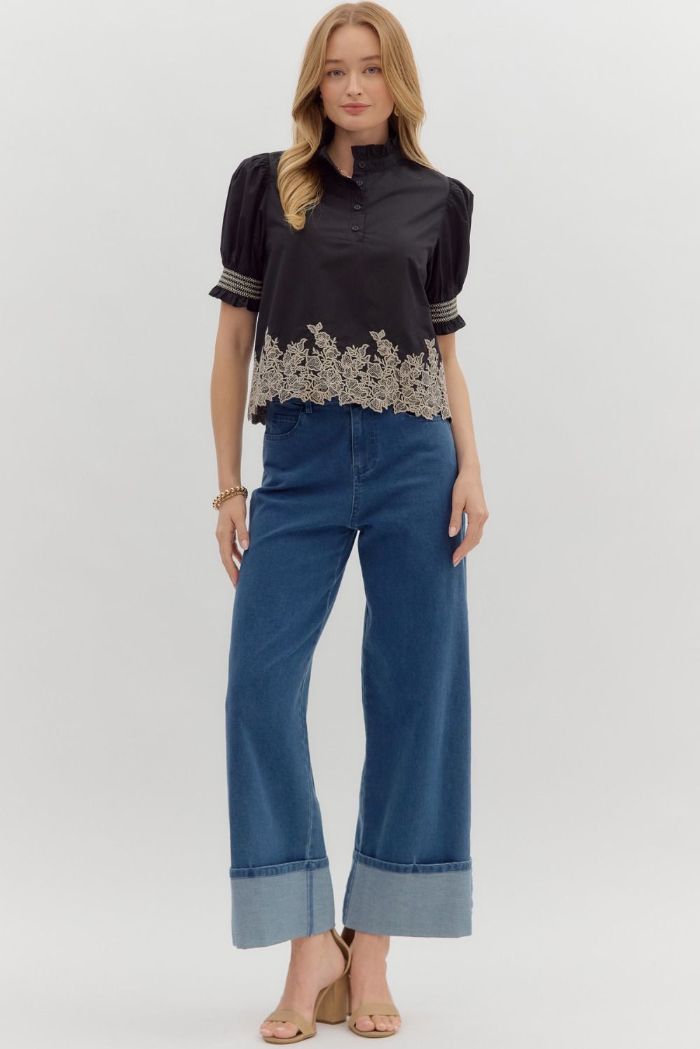 Women's black puff sleeve top with cream embroidered floral details by Entro showing full front view