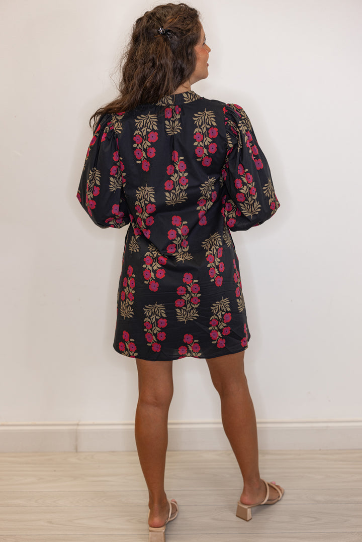 back view of Women's black and magenta floral mini dress