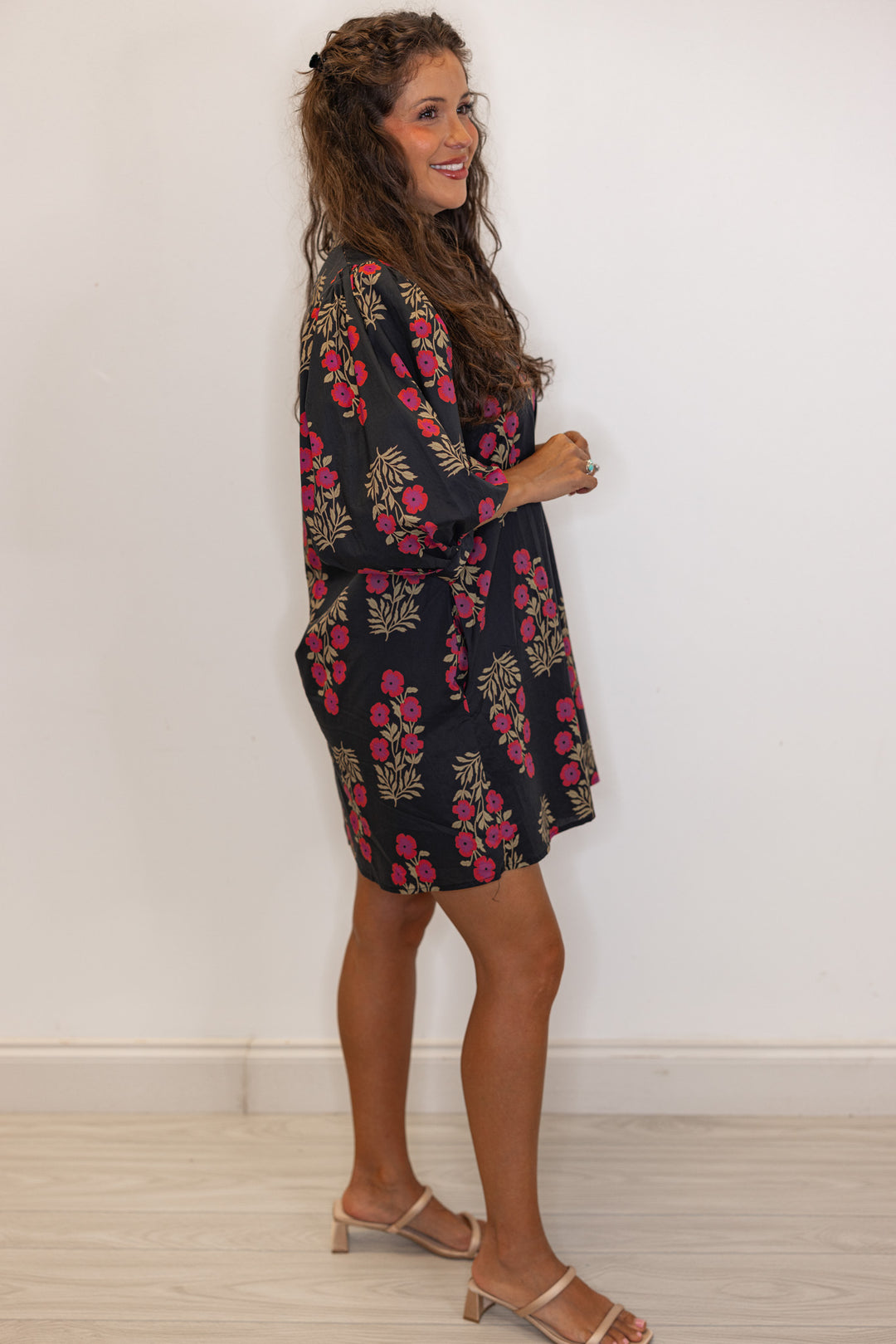 side view of Women's black and magenta floral mini dress