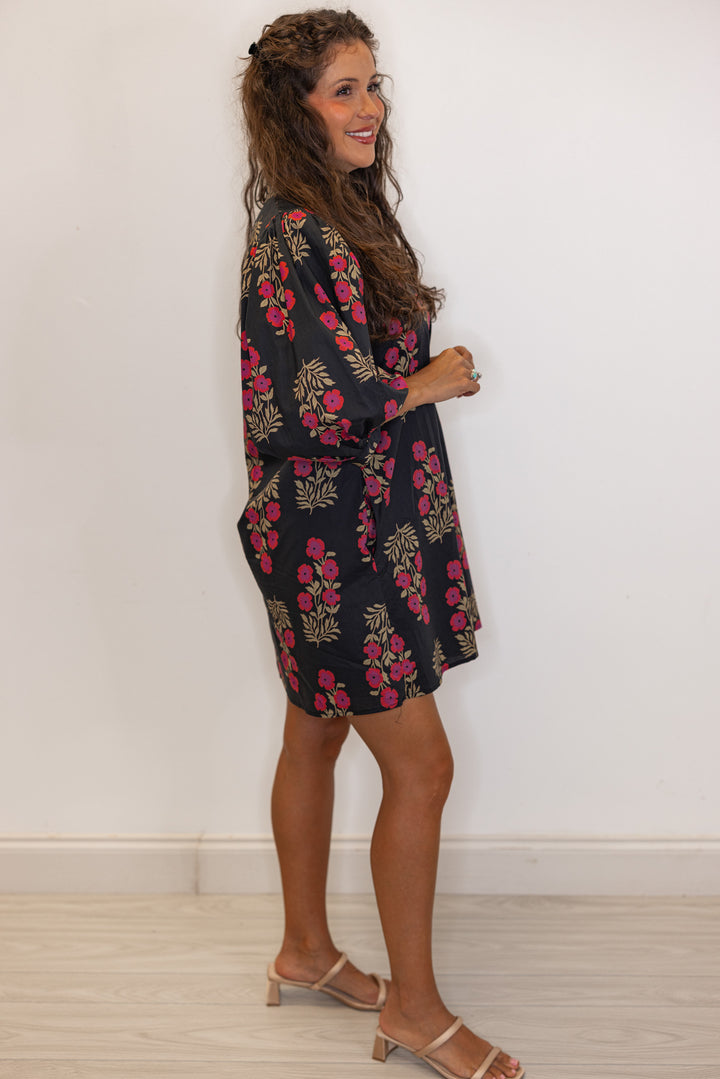 side view of Women's black and magenta floral mini dress