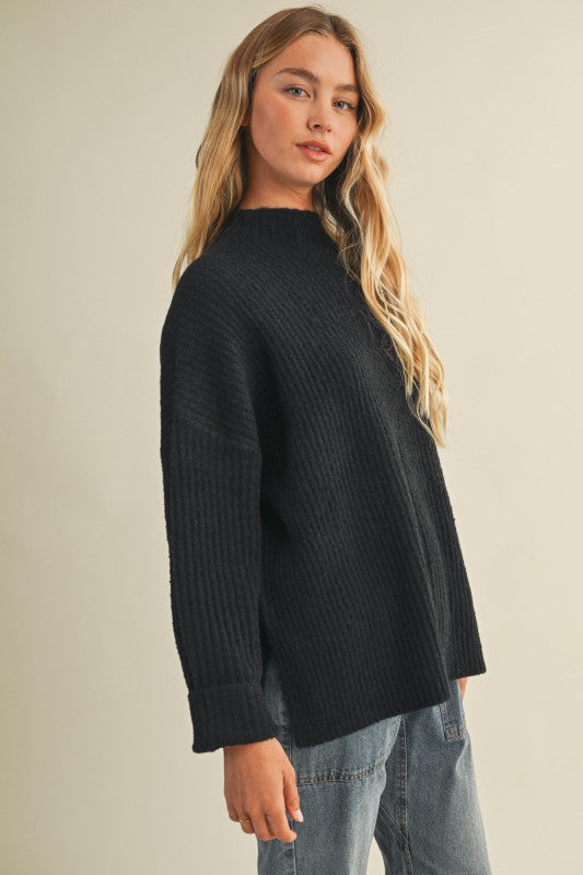 Women's black ribbed knit mock neck sweater top with side slits by Mustard Seed showing side view