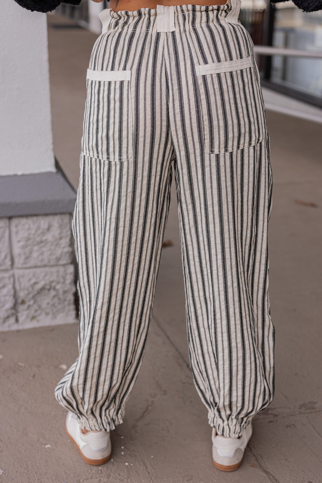 Women's oatmeal linen cargo jogger pants with black stripes by ee:some showing back view