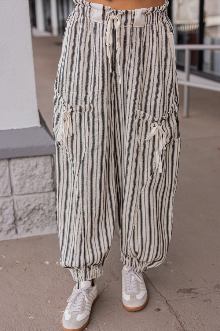 Women's oatmeal linen cargo jogger pants with black stripes by ee:some showing up close front view