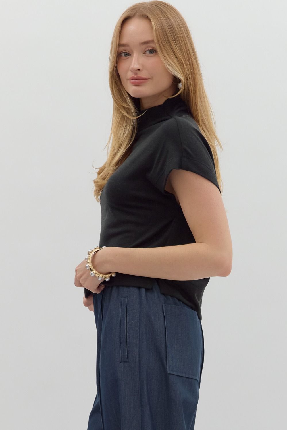 Women's black knit cropped top by Entro showing side view