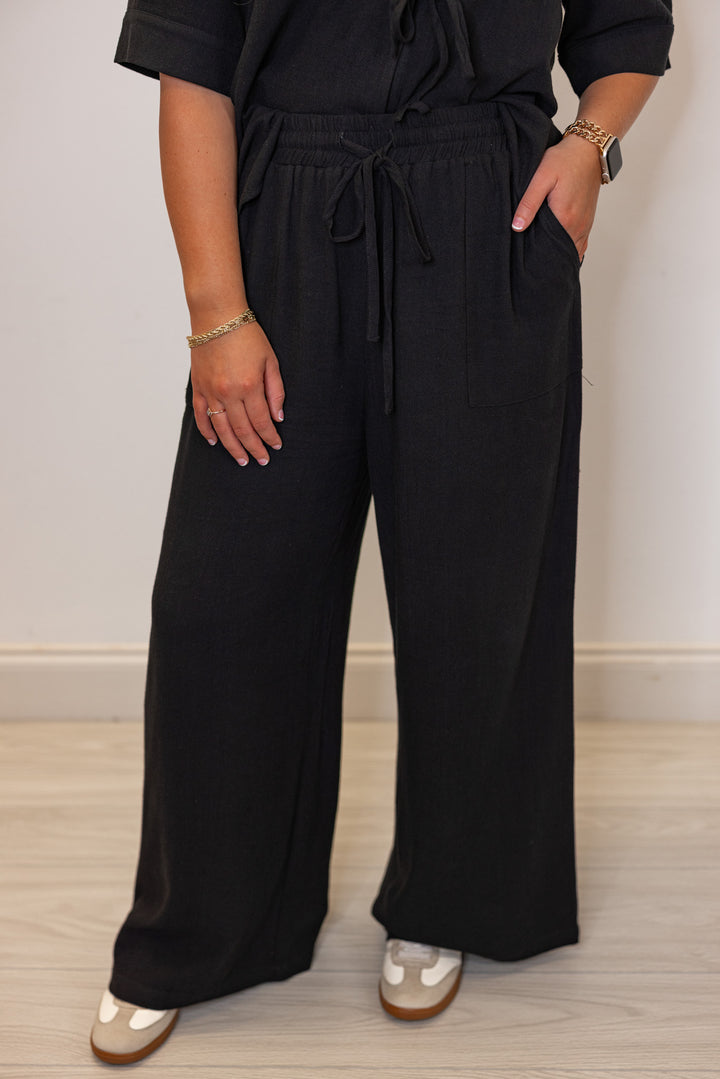 Women's black linen bow tie top and elastic waist wide leg pants set by Jodifl   showing up close front view of pants