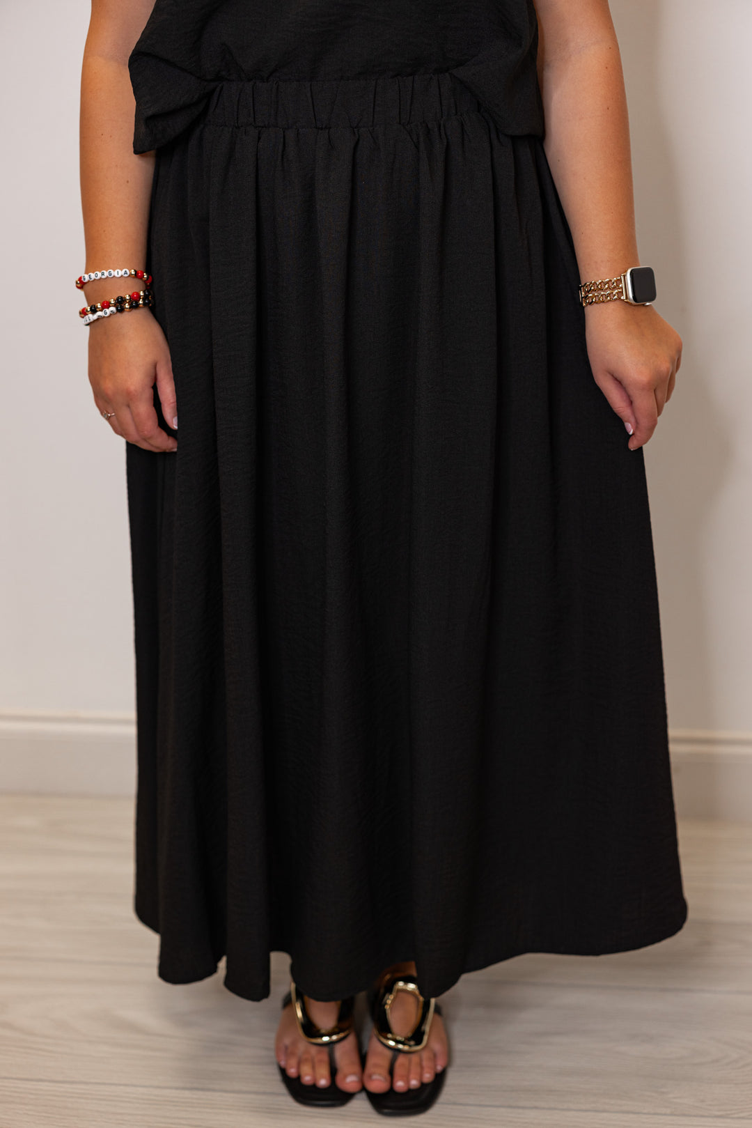 Women's black textured midi skirt with pleats by Entro showing up close front view