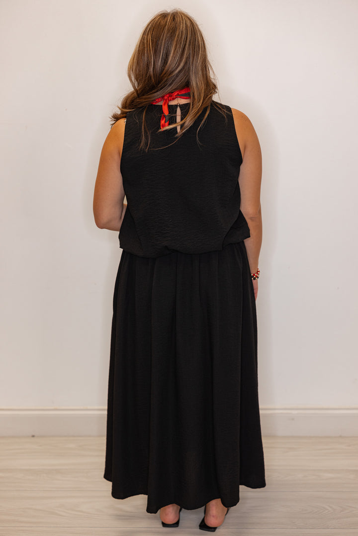 Women's black textured midi skirt with pleats by Entro showing full back view