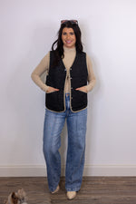 women's black quilted tan trim vest