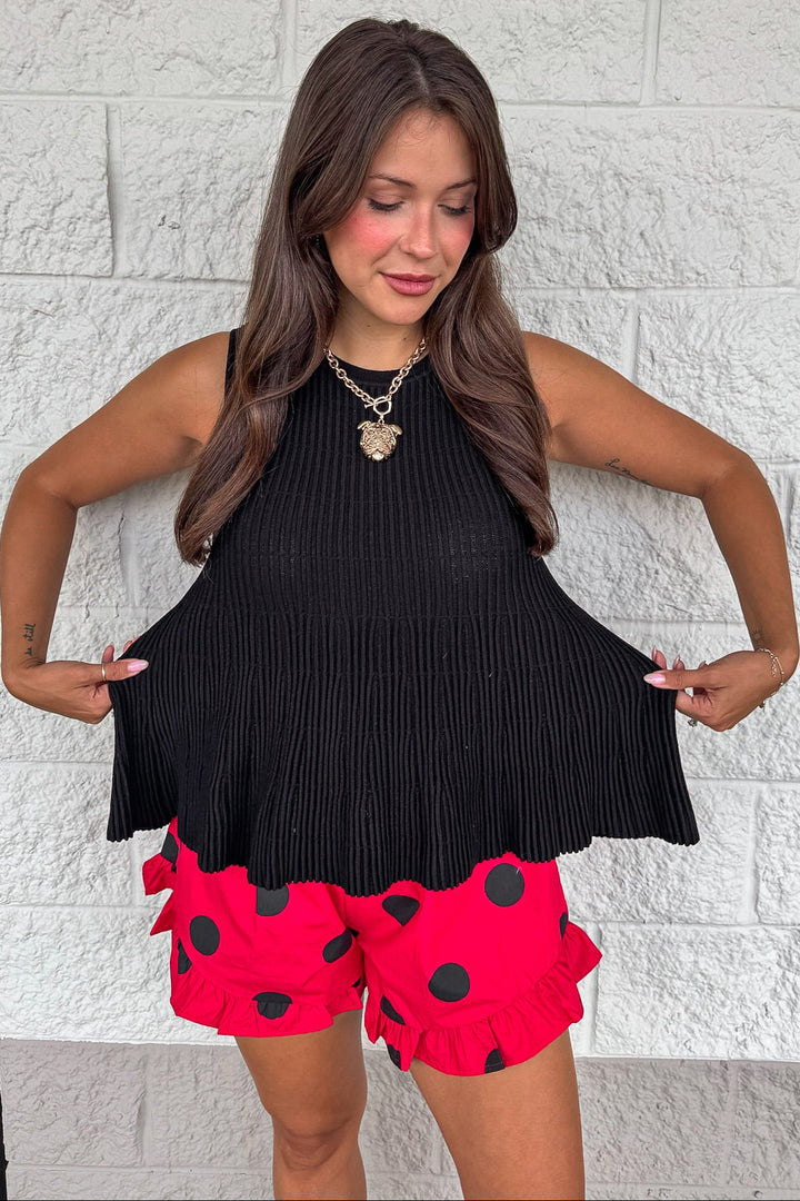 solid black crew neckline sleeveless peplum style relaxed silhouette ribbed knit top