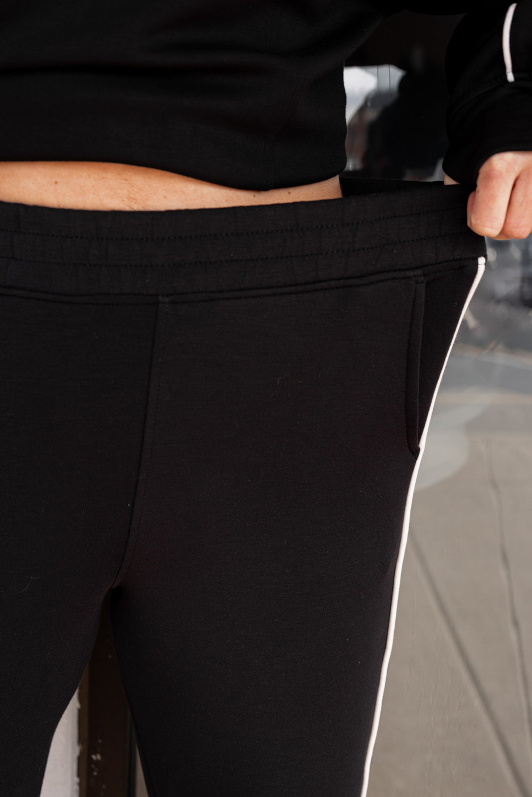 Women's black scuba knit straight leg elastic waist pants by Rae Mode showing elastic waistband