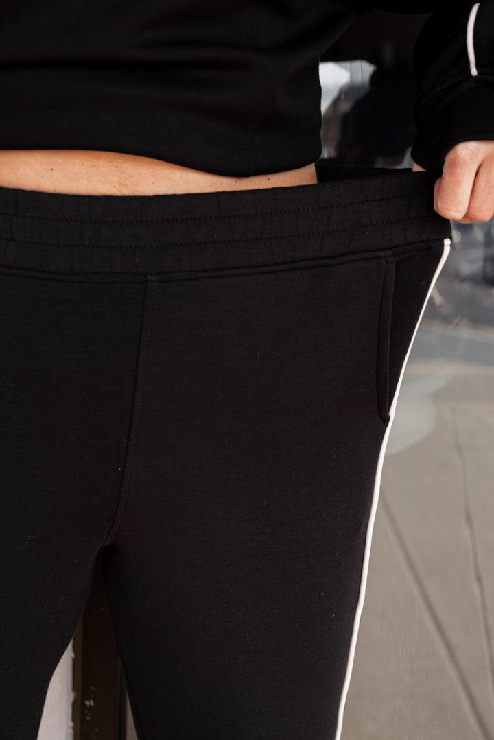 Women's black scuba knit straight leg elastic waist pants by Rae Mode showing elastic waistband