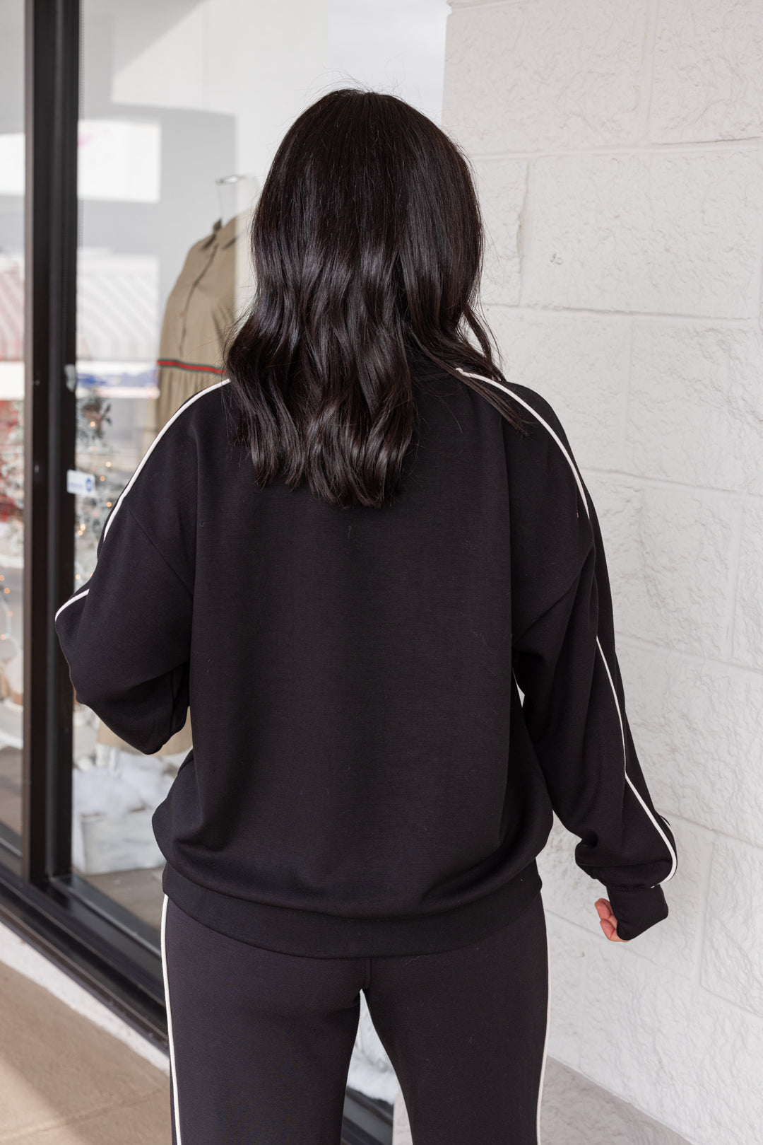 Women's black scuba knit mock neck top by Rae Mode showing up close back view