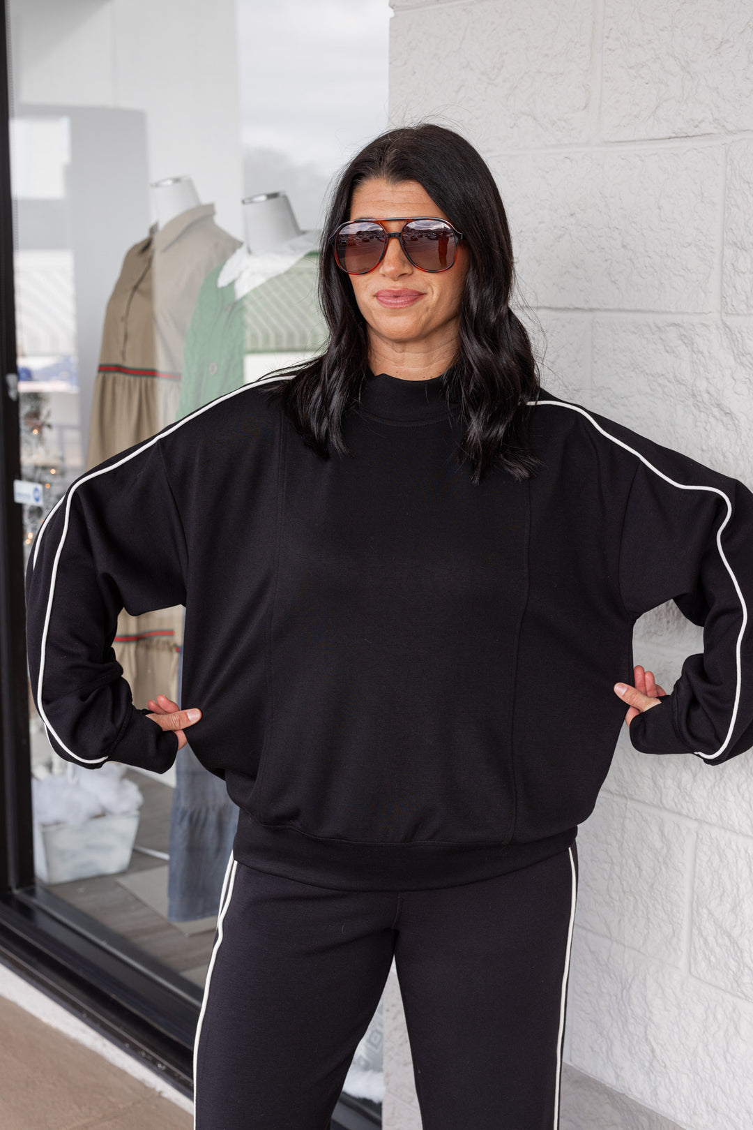 Women's black scuba knit mock neck top by Rae Mode showing true to size fit