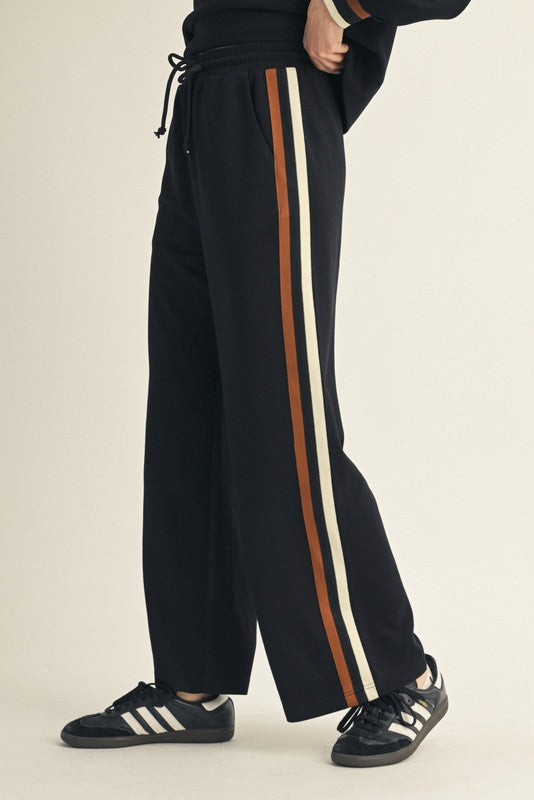 Women's black scuba knit pants with ribbed colorblock trim by Jodifl showing side view