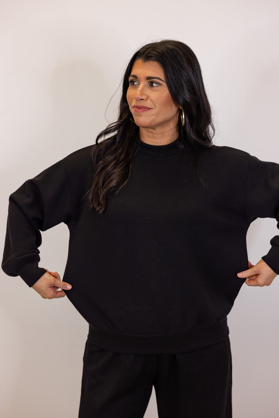 Black scuba knit mock neck pullover top by Rae Mode showing true to size fit