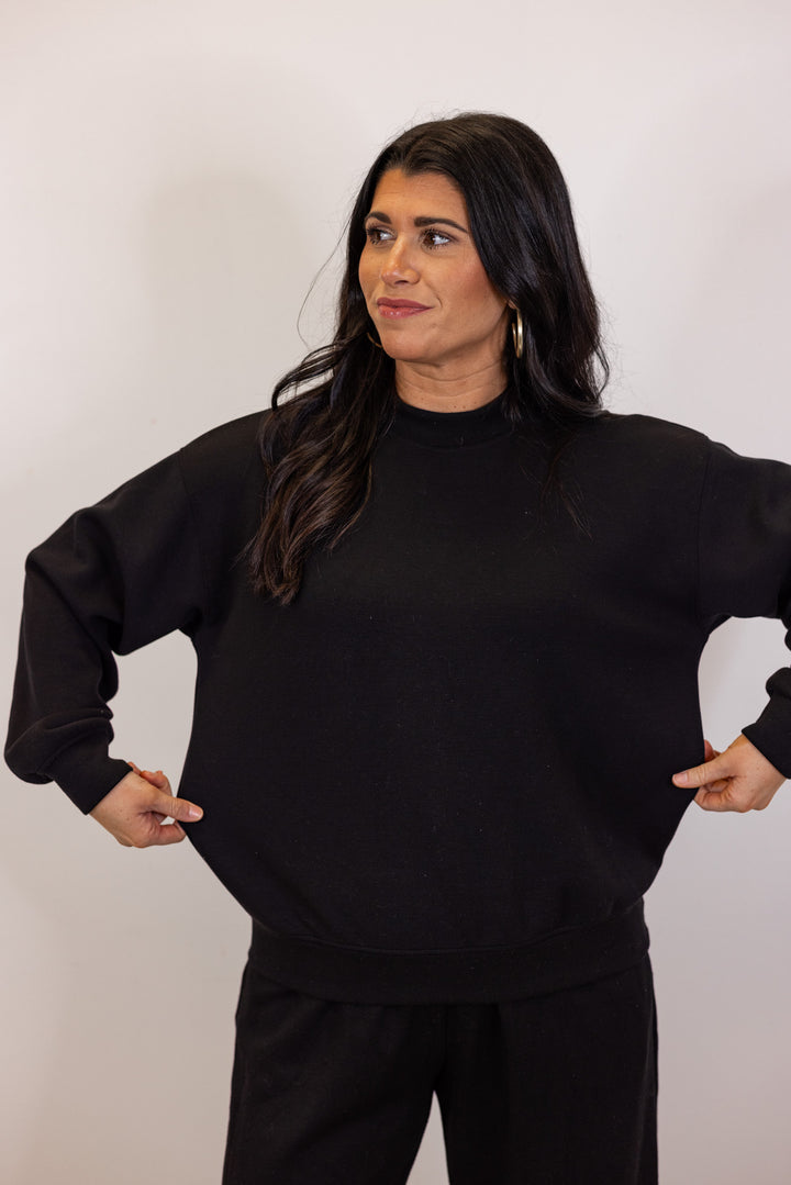 Black scuba knit mock neck pullover top by Rae Mode showing true to size fit