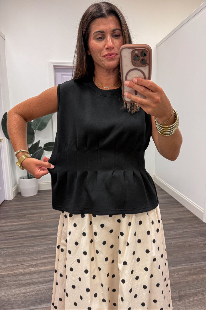 solid black crew neckline sleeveless luxe knit ruffled peplum hem top