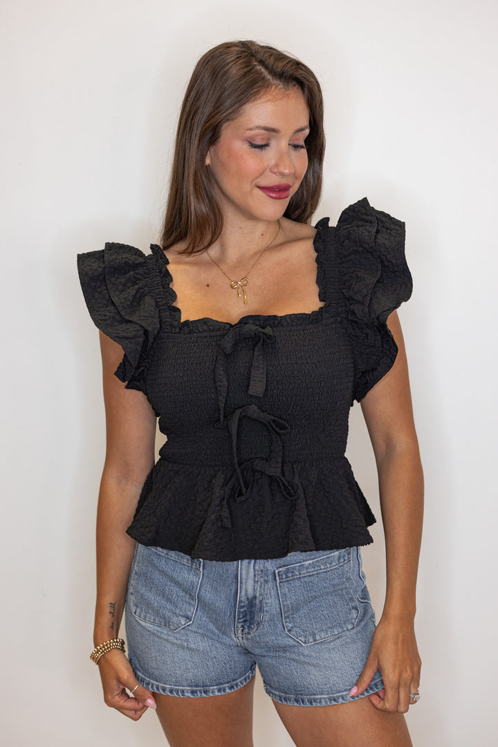 black smocked peplum bow top