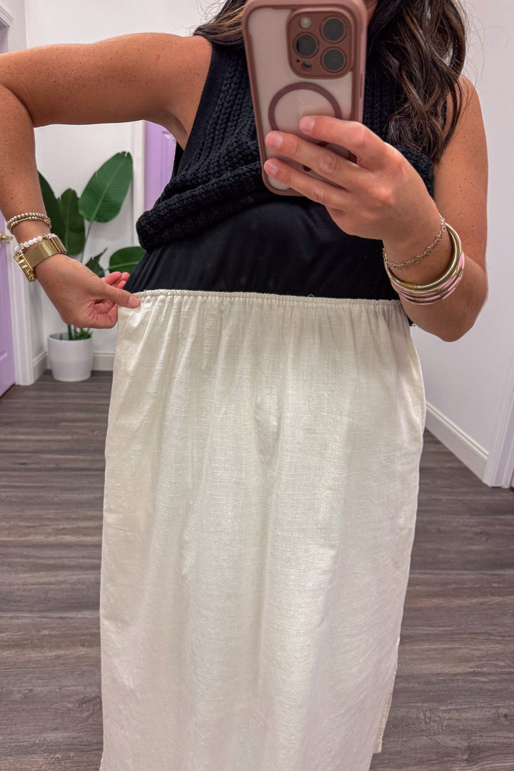 midi dress with black sweater top and cream elastic waistband cotton skirt