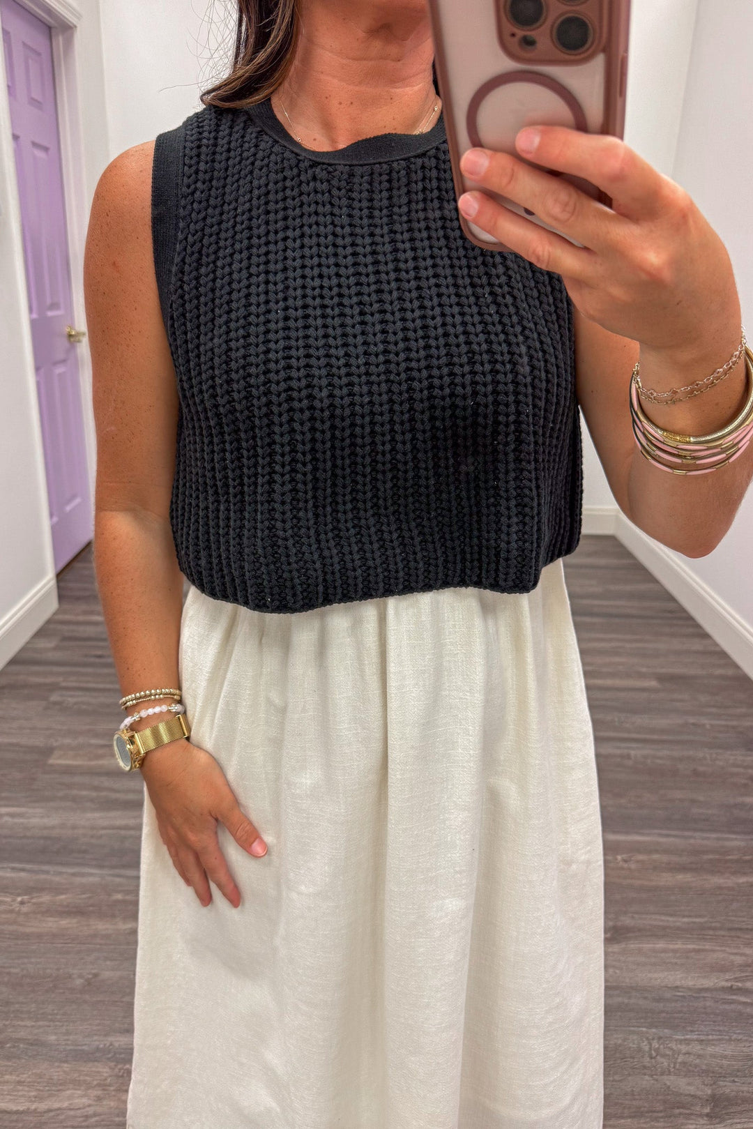 midi dress with black sleeveless crew neckline sweater top and cream cotton skirt