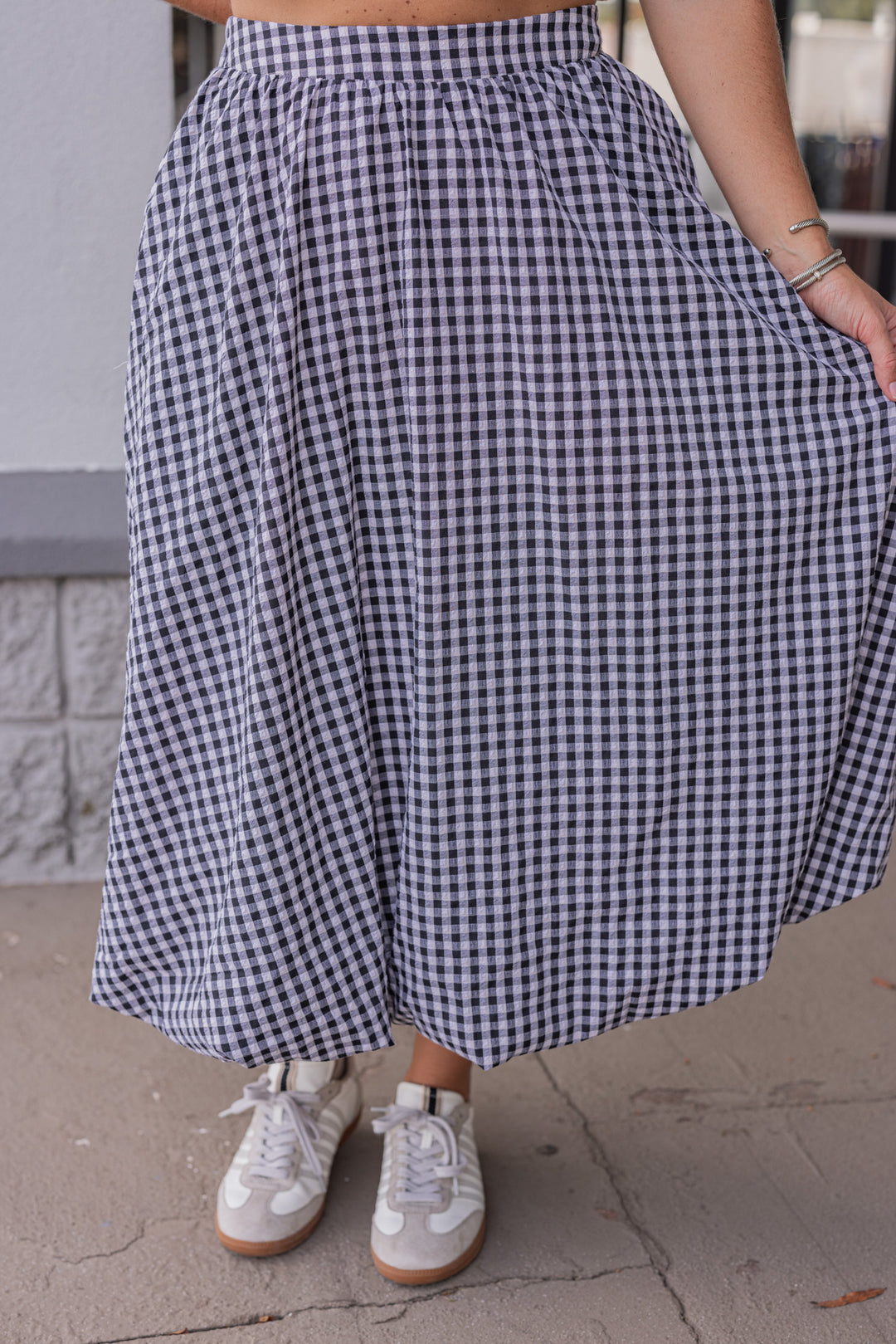 Women's black and white gingham textured midi skirt with bubble hem by Easel showing flowy fit
