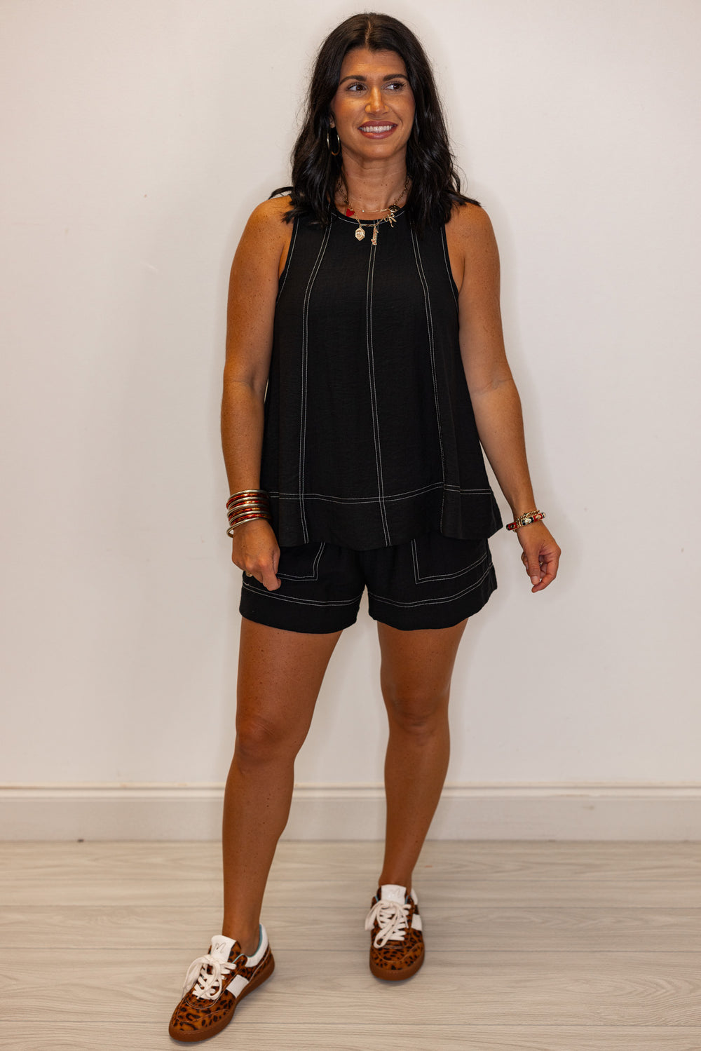 Black sleeveless top with white stitching by Entro showing full front view