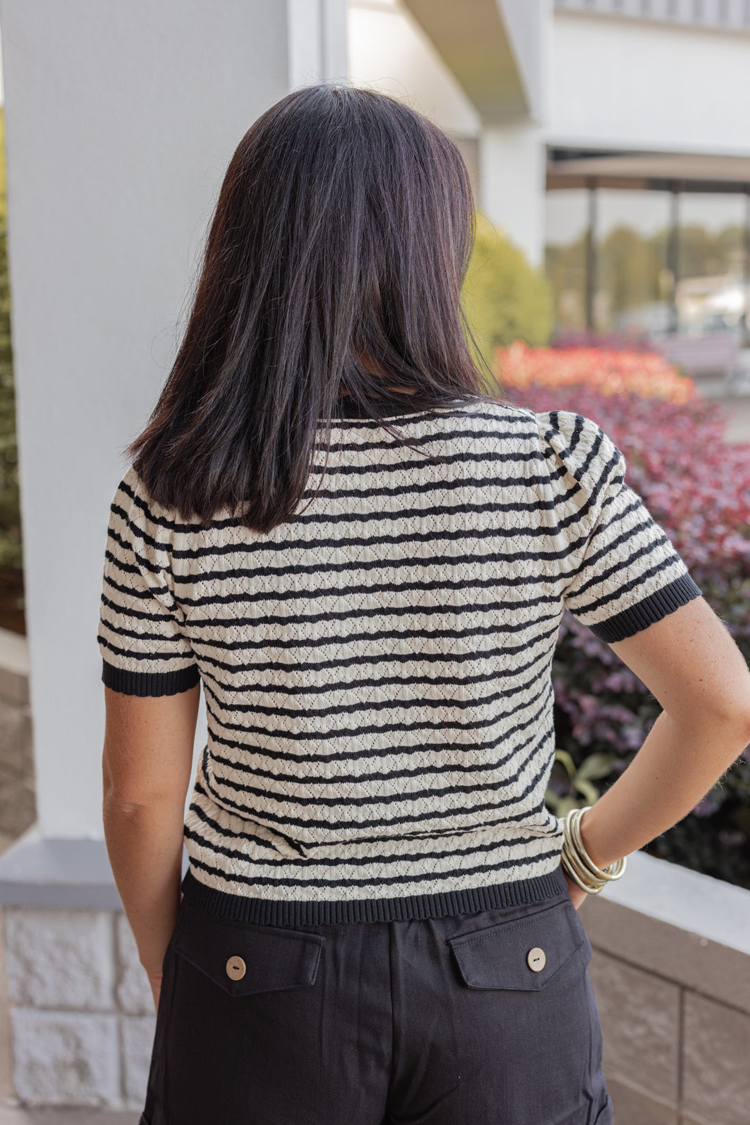 Women's black and cream striped knit top with scalloped trim by Entro showing up close back view